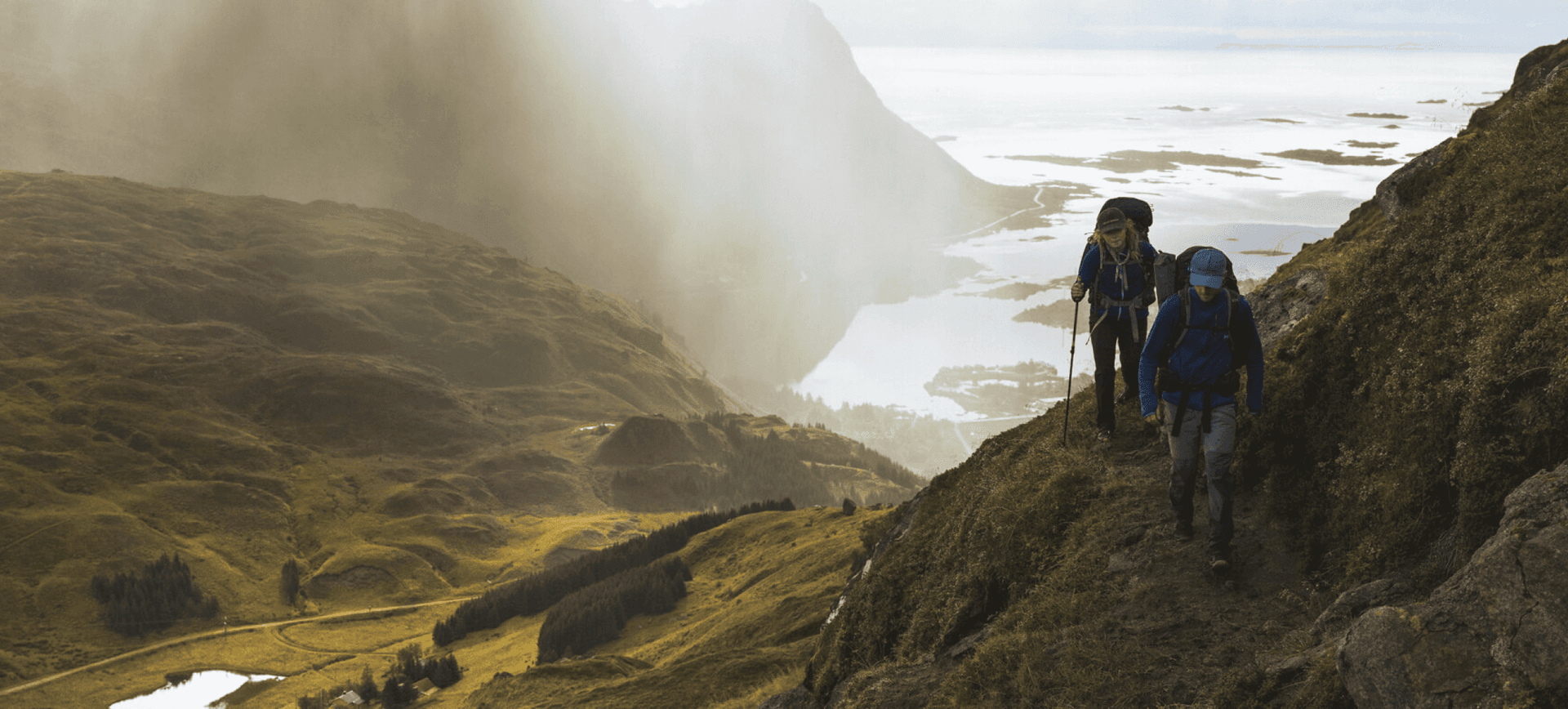 a couple of people walking up a hill